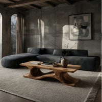 Minimal coffee table with an S curve waist base in a concrete and timber loft