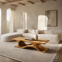 Minimal coffee table with an S curve waist base in an open plan space in daylight