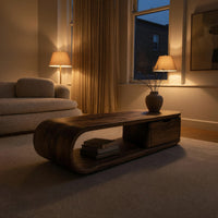Long loop coffee table with a side drawer box in an evening room lit by two lamps