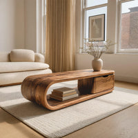Long loop coffee table with a side drawer box in a bright modern living room