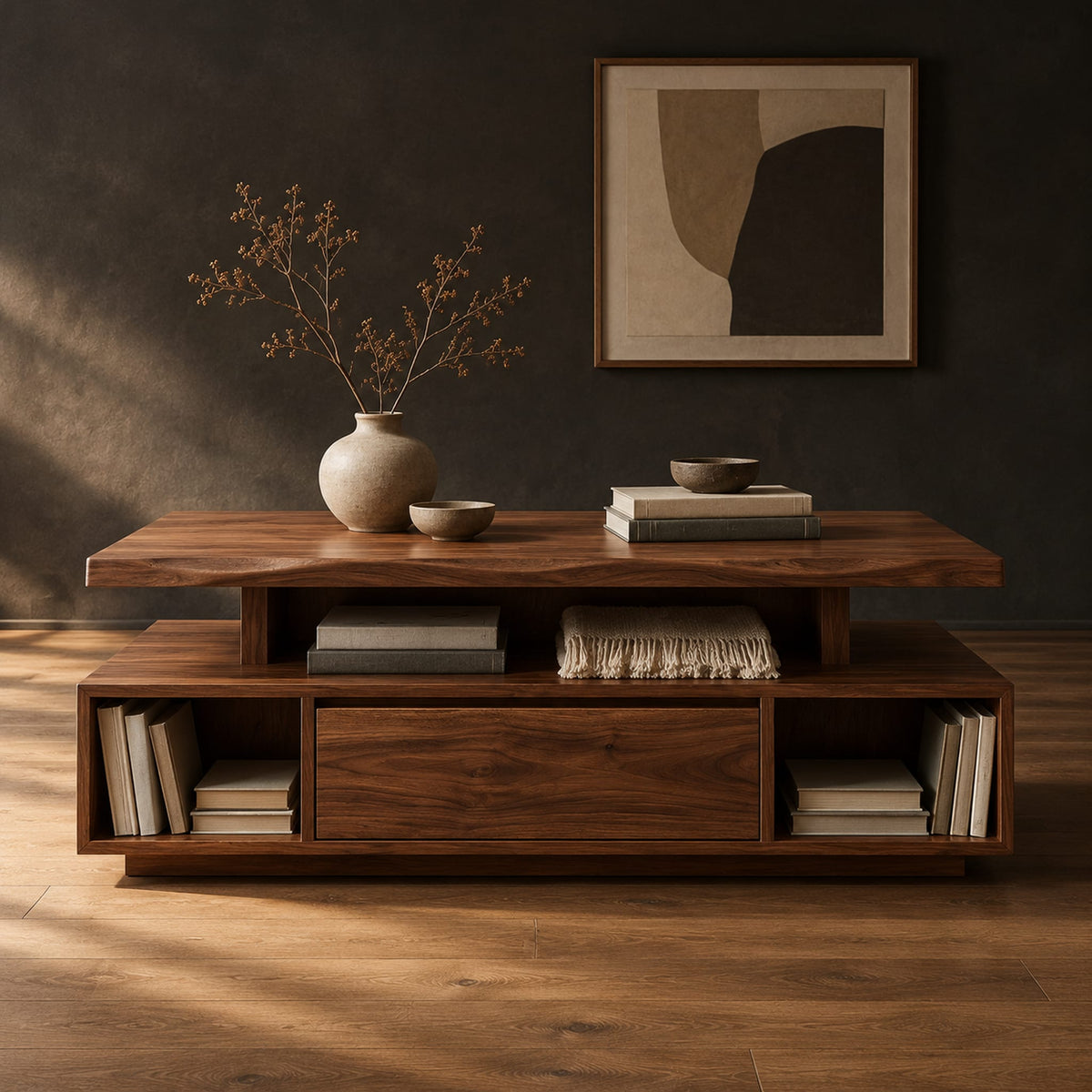Coffee table with a floating slab top and open end bays in a dark studio against a charcoal plaster wall
