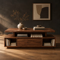 Coffee table with a floating slab top and open end bays in a dark studio against a charcoal plaster wall