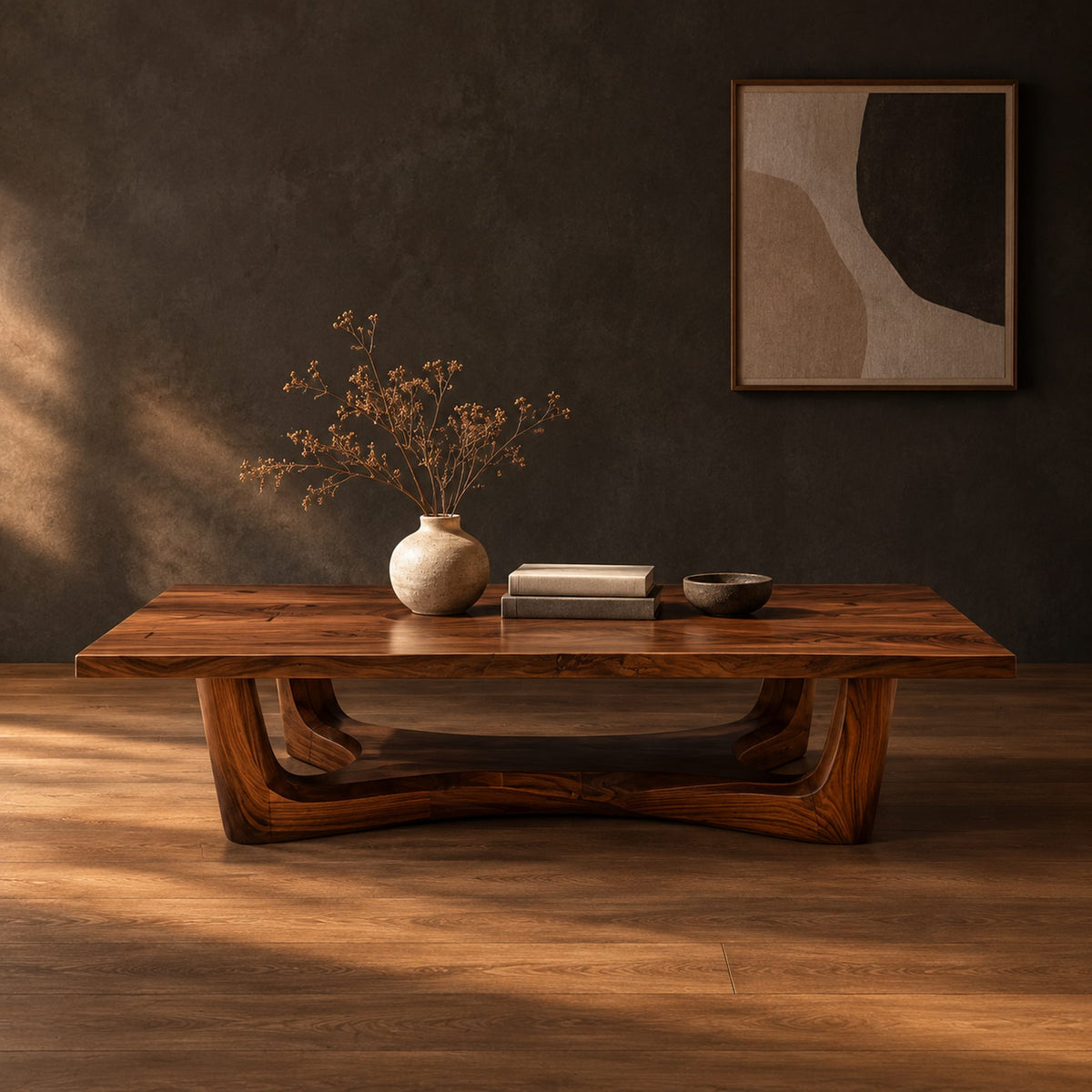 Rectangular coffee table on an arched trestle base with a low curved beam in a dark studio against a charcoal plaster wall