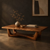 Rectangular coffee table on an arched trestle base with a low curved beam, three-quarter view showing the grain