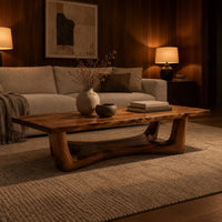 Rectangular coffee table on an arched trestle base with a low curved beam in an evening living room with walnut wall paneling
