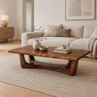 Rectangular coffee table on an arched trestle base with a low curved beam in a Scandinavian living room with white walls