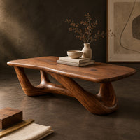 Corner detail of coffee table with an irregular soft edged top on sculpted branching legs beside wood, brass and linen samples