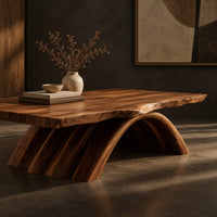Corner detail of coffee table with a natural edge top on a fanned arch base beside wood, brass and linen samples