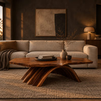 Coffee table with a natural edge top on a fanned arch base in a dark living room at golden hour
