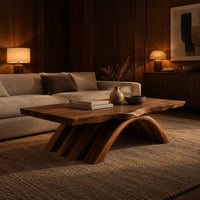 Coffee table with a natural edge top on a fanned arch base in an evening living room with walnut wall paneling