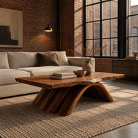 Coffee table with a natural edge top on a fanned arch base in an industrial loft living room with exposed brick