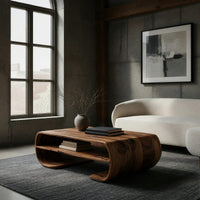 Coffee table with rolled ends and a double open shelf in a concrete and timber loft