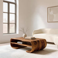 Coffee table with rolled ends and a double open shelf in an open plan space in daylight