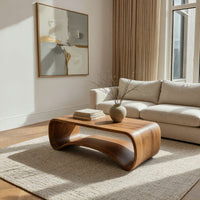 Compact loop coffee table with a small drawer in a bright modern living room