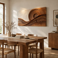 Rectangular wood wall art with concentric rings above flowing carved wave bands beside a dining table in natural light