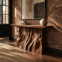 Console table with a deeply ridged sculpted block base in an industrial loft entryway with exposed brick