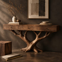 Corner detail of console table with three front panels on a branching tree shaped base beside wood, brass and linen samples