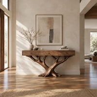 Console table with three front panels on a branching tree shaped base in a bright open plan entryway