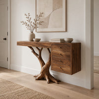 Console table on a branching trunk base with a four drawer block in a Scandinavian entryway with white walls