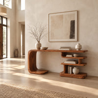 Long console table with a bent side panel and stacked open shelves in a bright open plan entryway