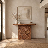 Console table with a spiral carved front and a slab top in a bright open plan entryway
