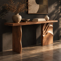Console table with a slab top and one leg carved in flowing waves, three-quarter view showing the grain