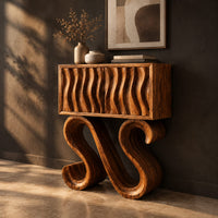 Wavy fluted console table on two large s shaped scroll legs, three-quarter view showing the grain