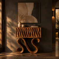 Wavy fluted console table on two large s shaped scroll legs in a dark entryway at golden hour