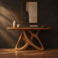 Oval console table on an open base of twisting interlocked loops in a dark studio against a charcoal plaster wall