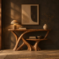 Wooden console table with a branching root base and a small lower shelf in a dark entryway at golden hour