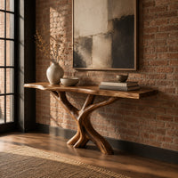 Console table with a thin natural edge top on a branching trunk base in an industrial loft entryway with exposed brick