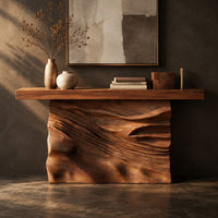 Corner detail of console table with a solid block base carved in dune ripples beside wood, brass and linen samples