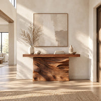 Console table with a solid block base carved in dune ripples in a bright open plan entryway