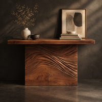 Corner detail of console table with a thick plank top and wave carved block base beside wood, brass and linen samples