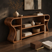 Corner detail of open shelf console table with wavy curved ends and a divided center bay beside wood, brass and linen samples