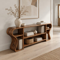 Open shelf console table with wavy curved ends and a divided center bay in a Scandinavian entryway with white walls