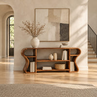 Open shelf console table with wavy curved ends and a divided center bay in a bright open plan entryway