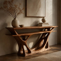 Corner detail of console table with a double layer top and a branching open base beside wood, brass and linen samples