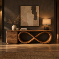 Console table on a figure eight loop base beside a three drawer block in a dark entryway at golden hour
