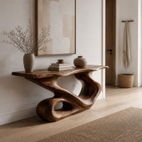 Narrow console table with a flowing s shaped base and an open loop foot in a Scandinavian entryway with white walls