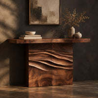 Console table with a thick top on a wave carved block base, three-quarter view showing the grain