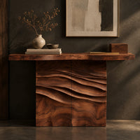 Corner detail of console table with a thick top on a wave carved block base beside wood, brass and linen samples