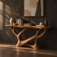 Oval top console table on a sculpted base of looping open limbs, three-quarter view showing the grain