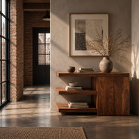 Console table with open shelves and a two door cabinet in an industrial loft entryway with exposed brick
