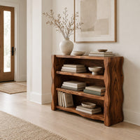 Open shelf console table with thick wavy edged side panels in a Scandinavian entryway with white walls