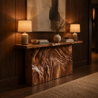 Console table on a block base carved with rippled ridges in an evening entryway with walnut wall paneling