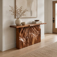 Console table on a block base carved with rippled ridges in a Scandinavian entryway with white walls