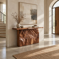 Console table on a block base carved with rippled ridges in a bright open plan entryway