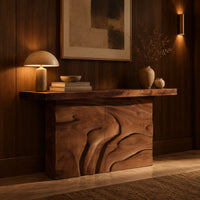 Console table on a solid base carved with flowing relief in an evening entryway with walnut wall paneling
