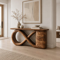 Console table with an infinity loop base and a stacked block at one end in a Scandinavian entryway with white walls